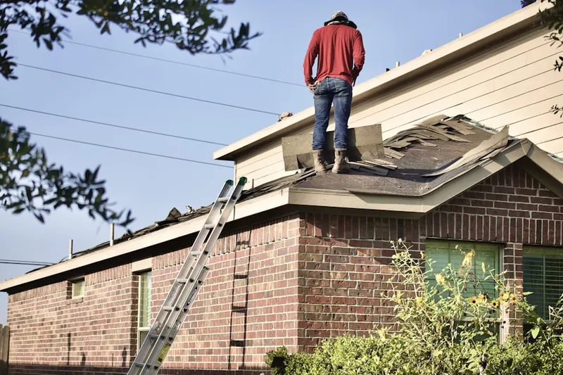 Professional roofer working on a residential roof in Estates at Whitemarsh